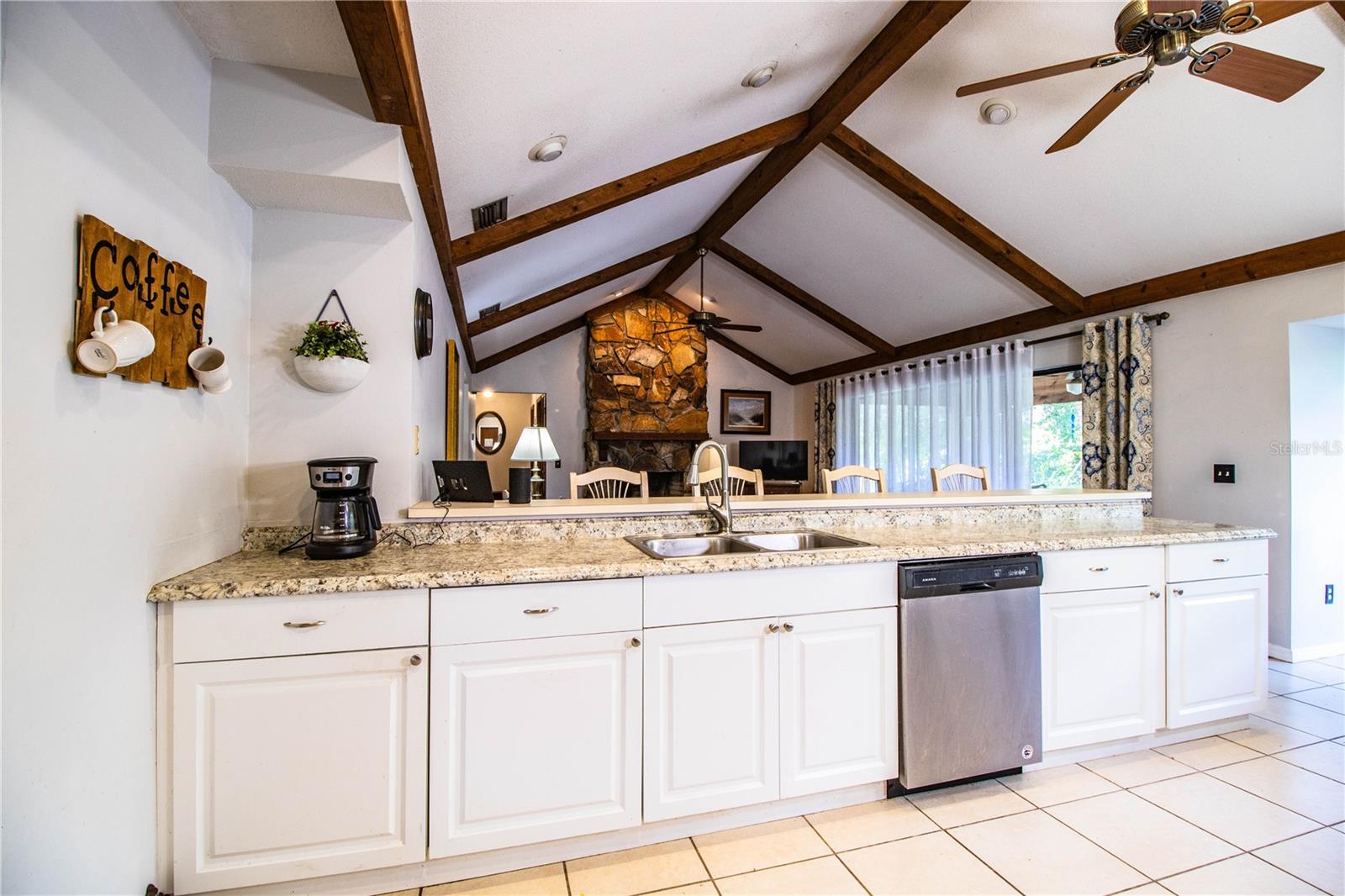 Updated kitchen with stainless steel appliances, large breakfast bar, and abundant natural light.