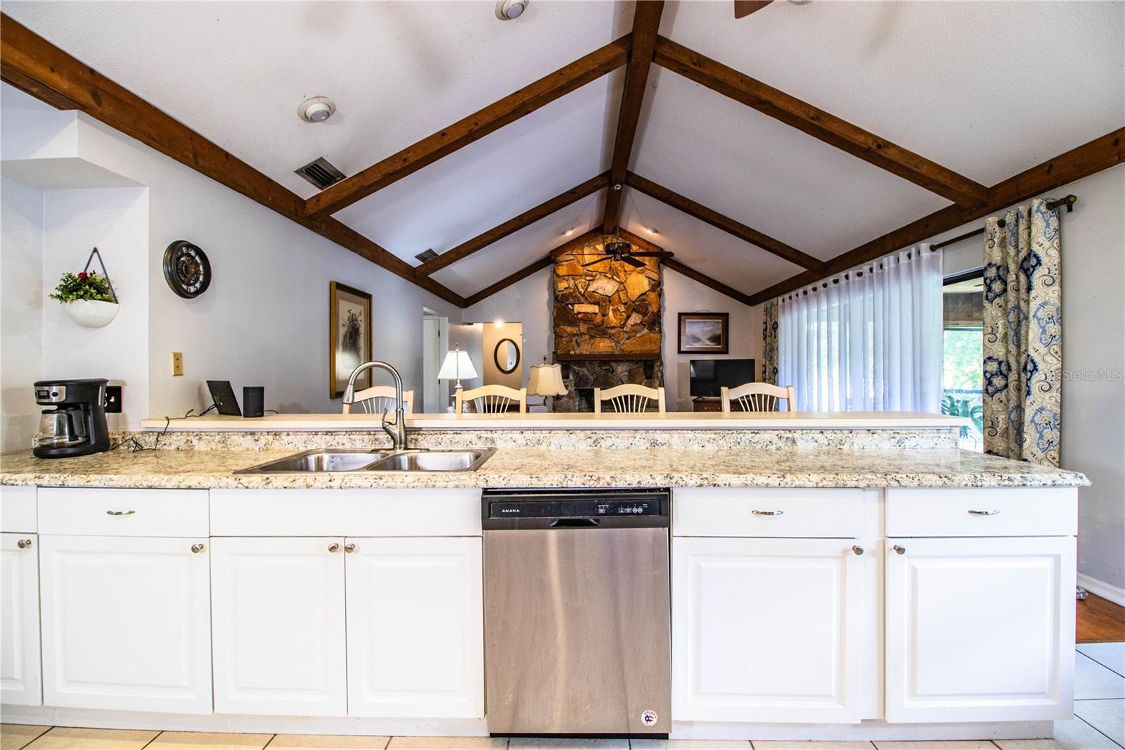Enjoy cooking in a bright kitchen with updated cabinets, undermount sink, and a view-filled dinette space.