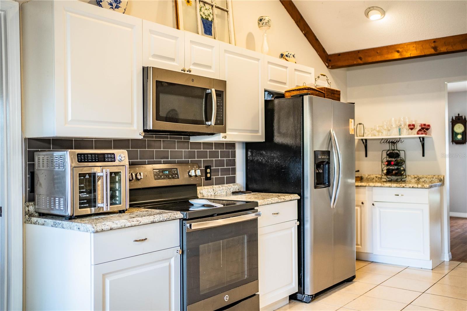 Bright and functional kitchen with room to entertain—bar seating, modern finishes, and natural light.