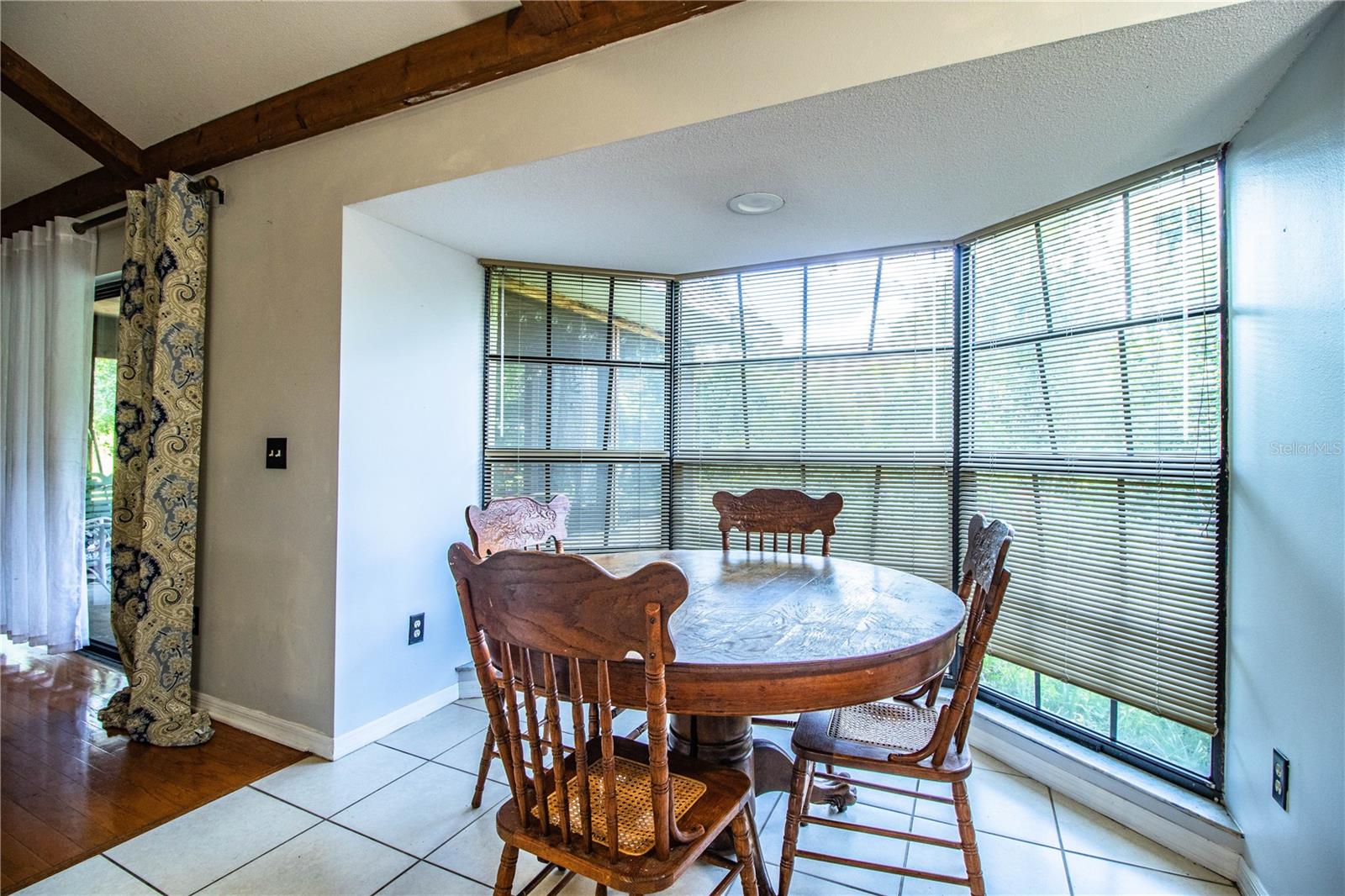 Bright dinette space with large windows and open sightlines to the kitchen and family room area.