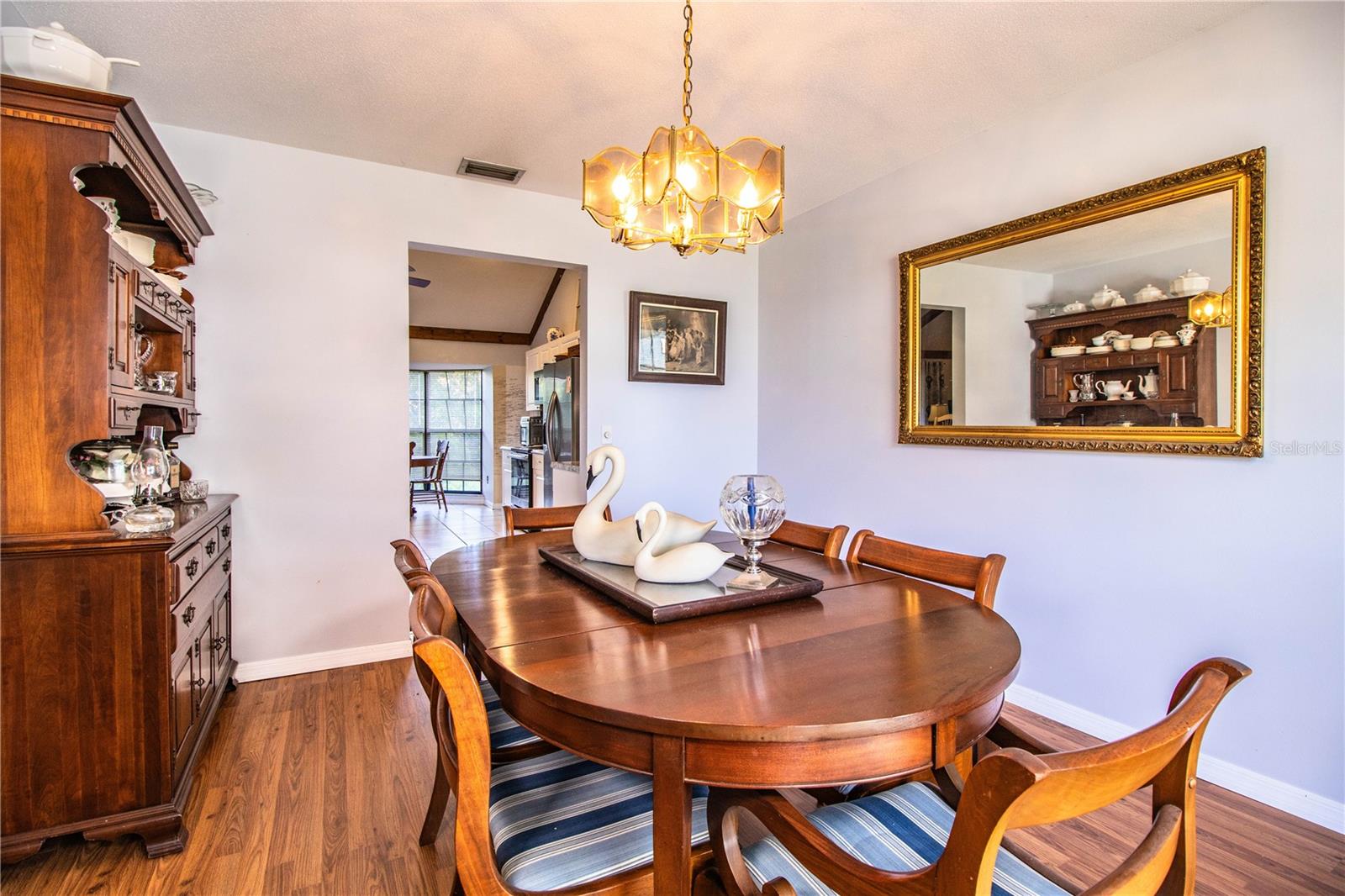 Host with ease in the spacious dining room, featuring hardwood floors and natural light.