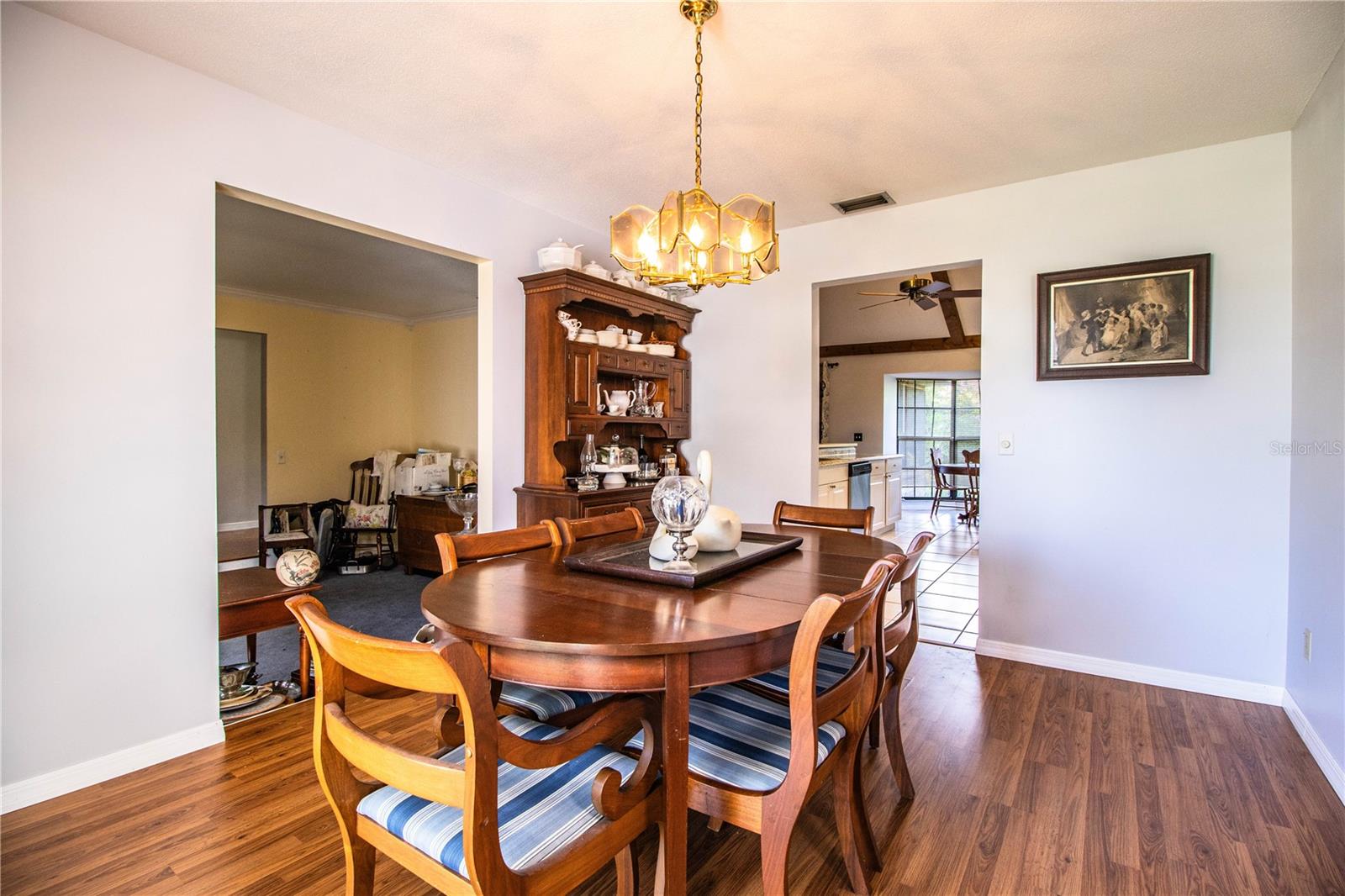 Formal dining area with beautiful wood flooring and open flow to both kitchen and living room.