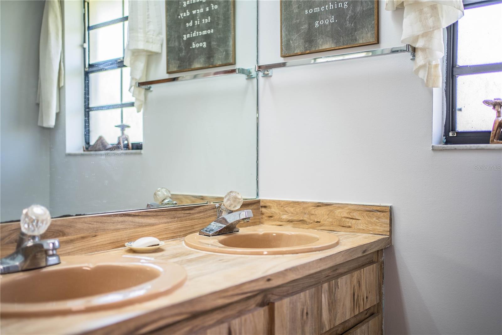 Dual vanities in the en suite bathroom offer generous counter space and plenty of storage for daily essentials.