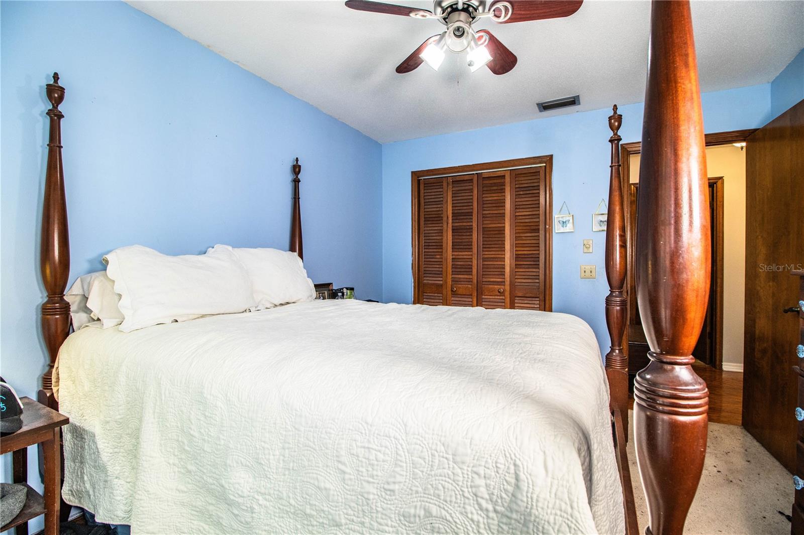 Bedroom 2 features a built-in closet, soft carpet underfoot, and a large window that fills the space with natural light.