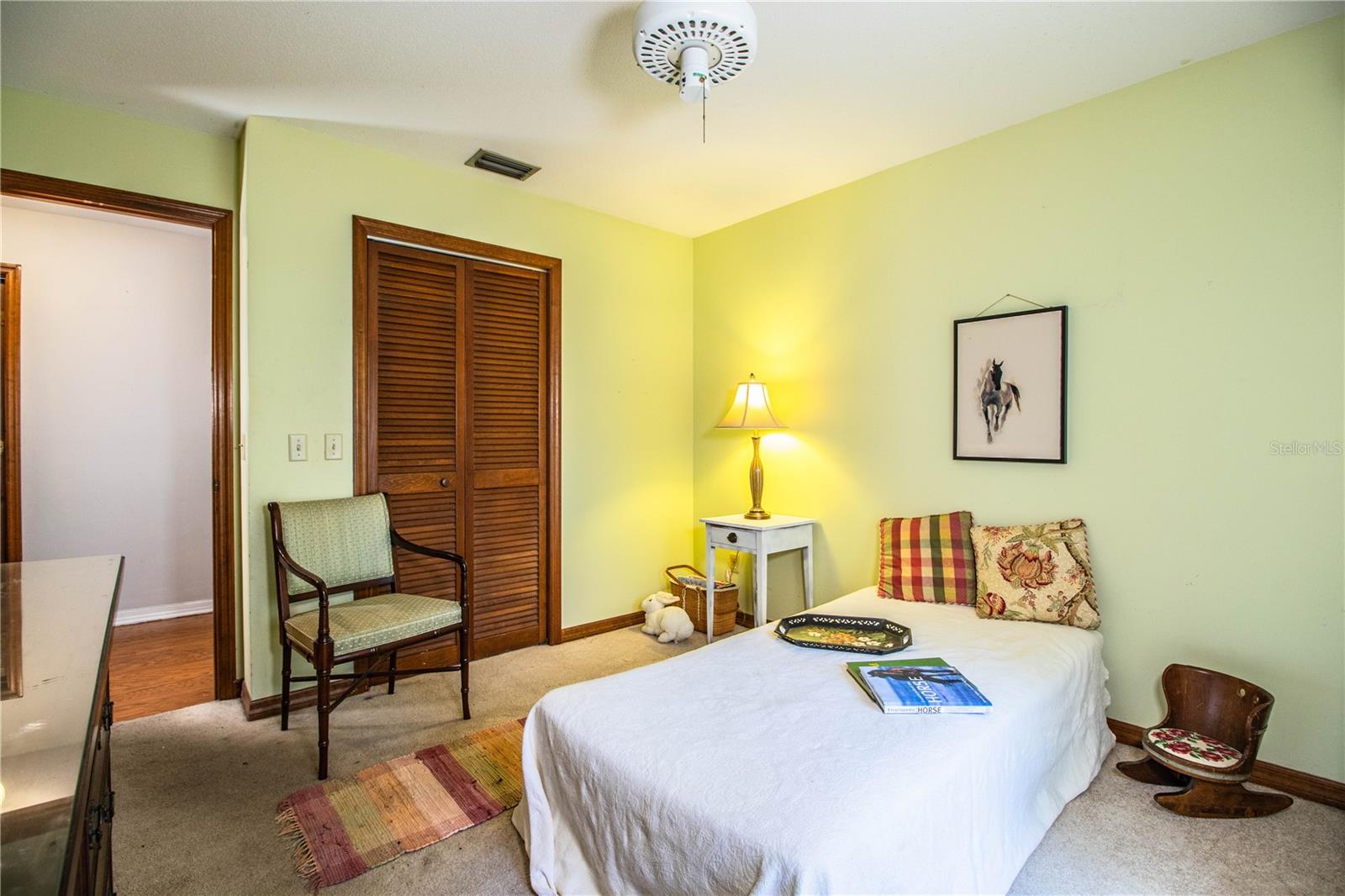 This comfortable third bedroom boasts carpet flooring, ample natural light, and built-in storage—perfect for guests or a hobby room.
