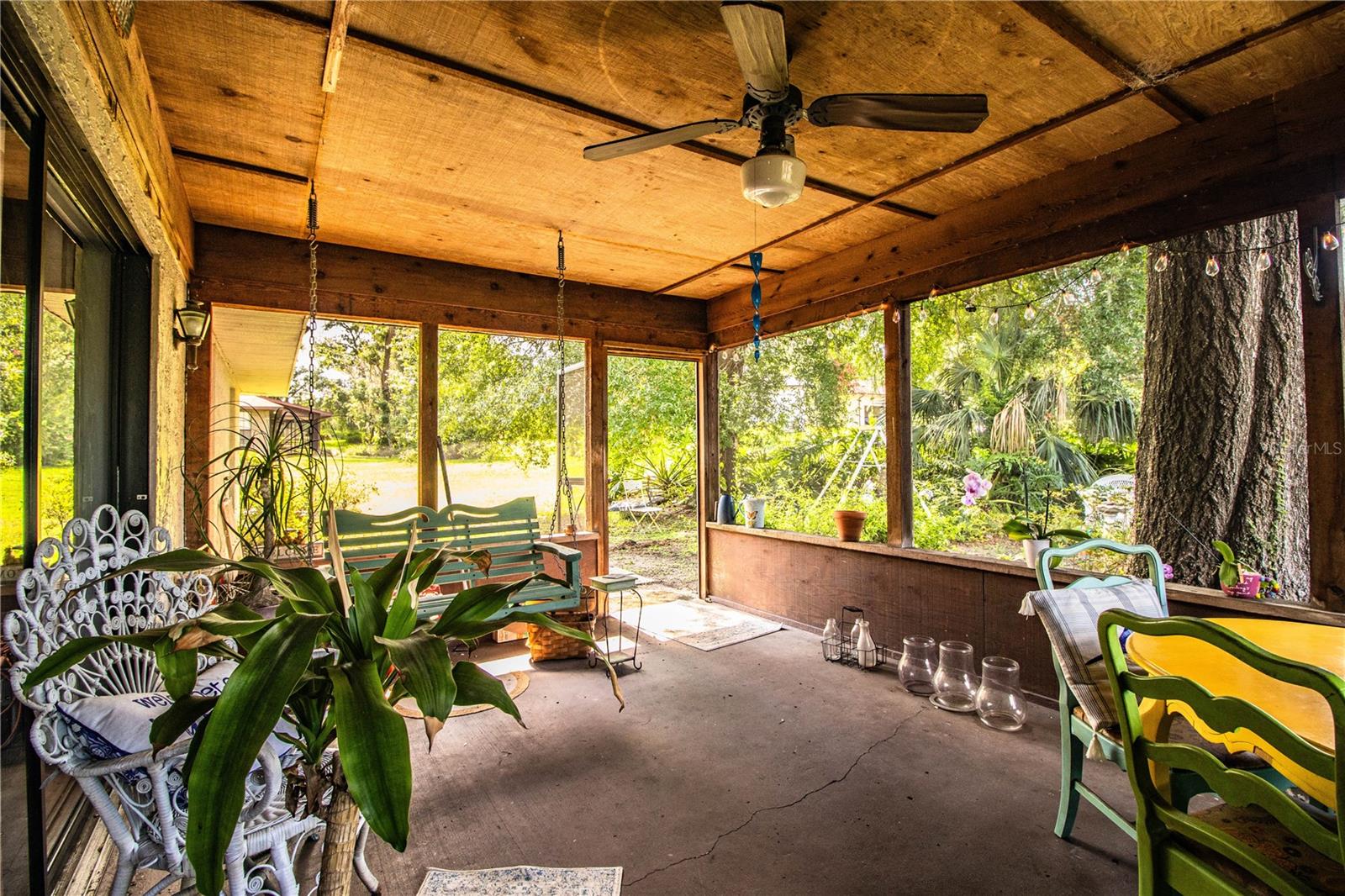 A spacious screened patio opens through triple sliding glass doors—perfect for entertaining or relaxing year-round.