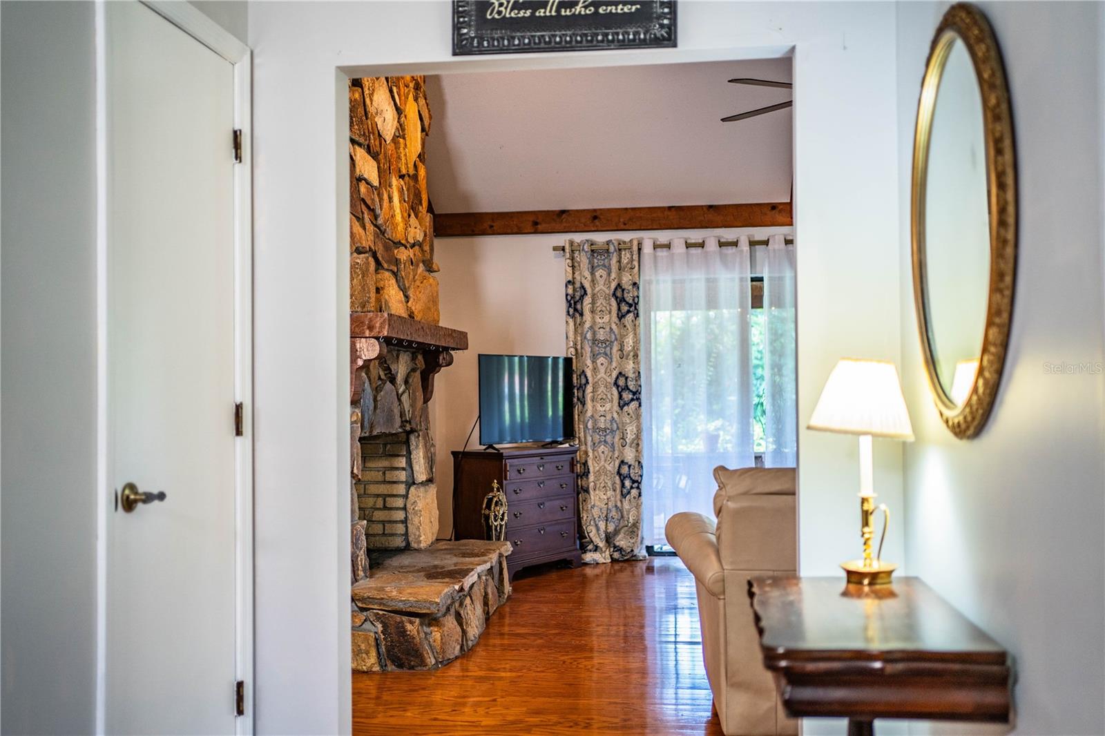 From the front door, enjoy an open view into the family room with a cozy fireplace and the adjacent living room.