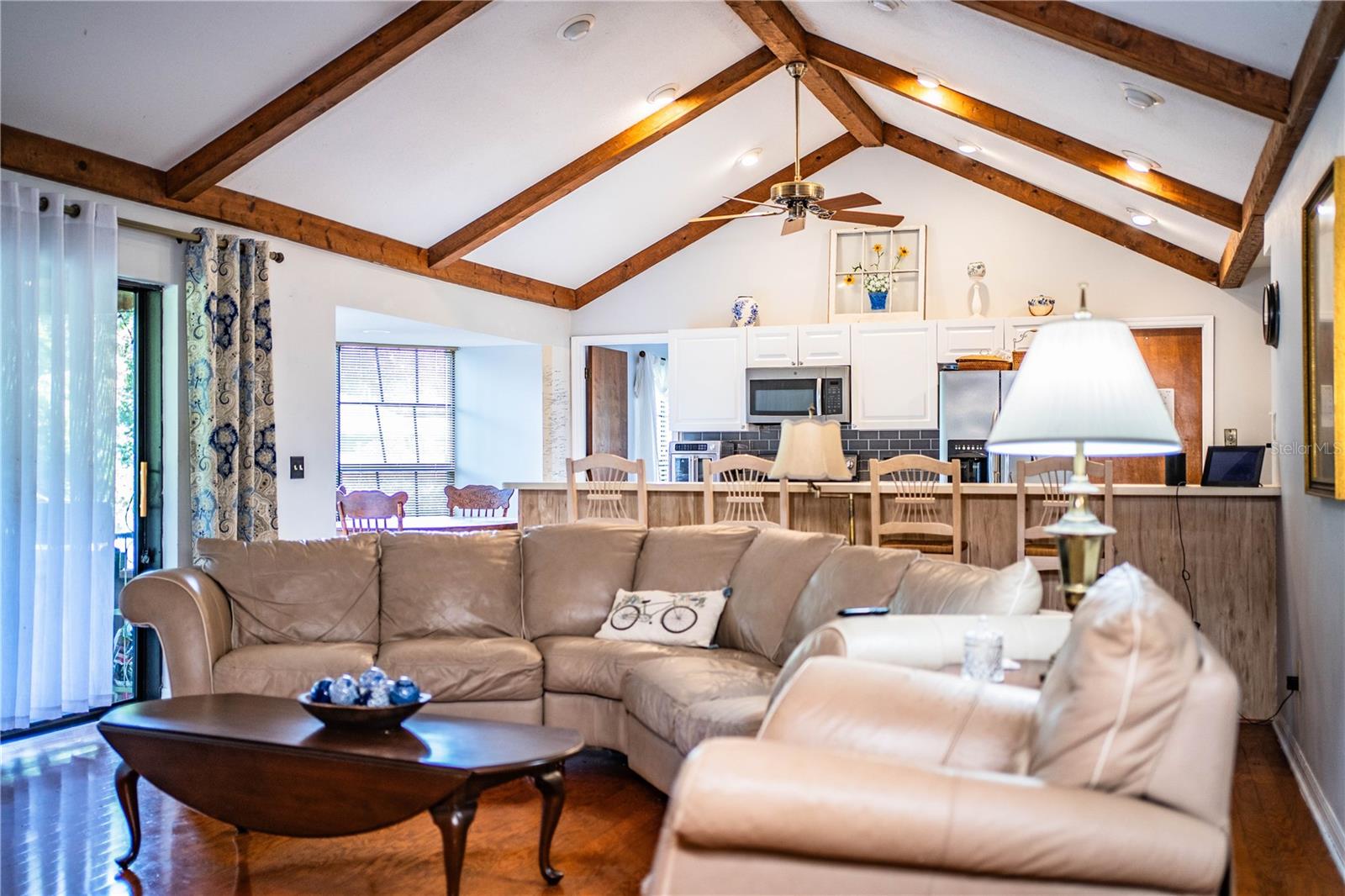 A perfect blend of comfort and function—open family room with beam-accented ceilings.