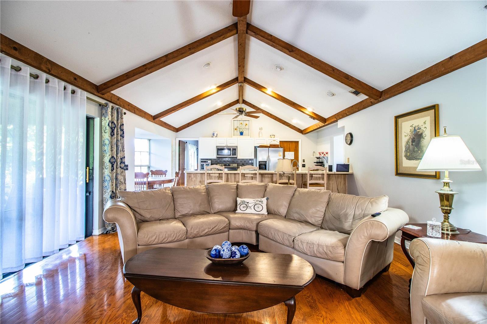Beams add style and warmth to the open layout connecting the family room to the kitchen.