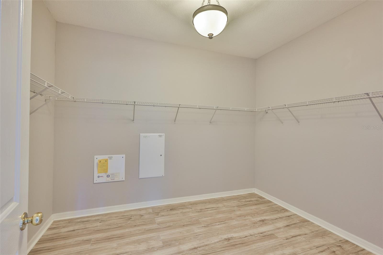 Primary bedroom walk-in closet - this is bigger than some rooms in houses!