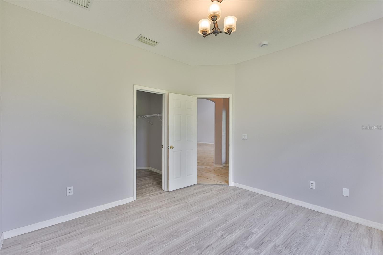 Bedroom 3, new ceiling fan, walk-in closet and new vinyl plank flooring