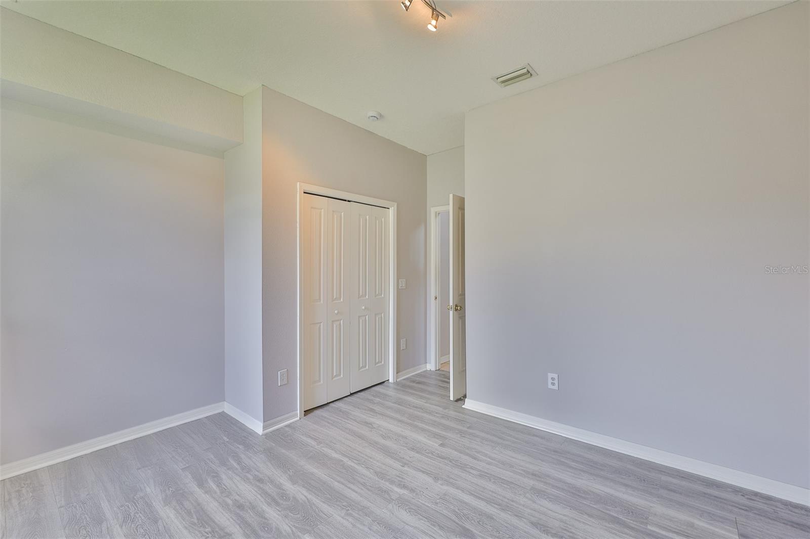 Bedroom 4, track lighting and new vinyl plank flooring