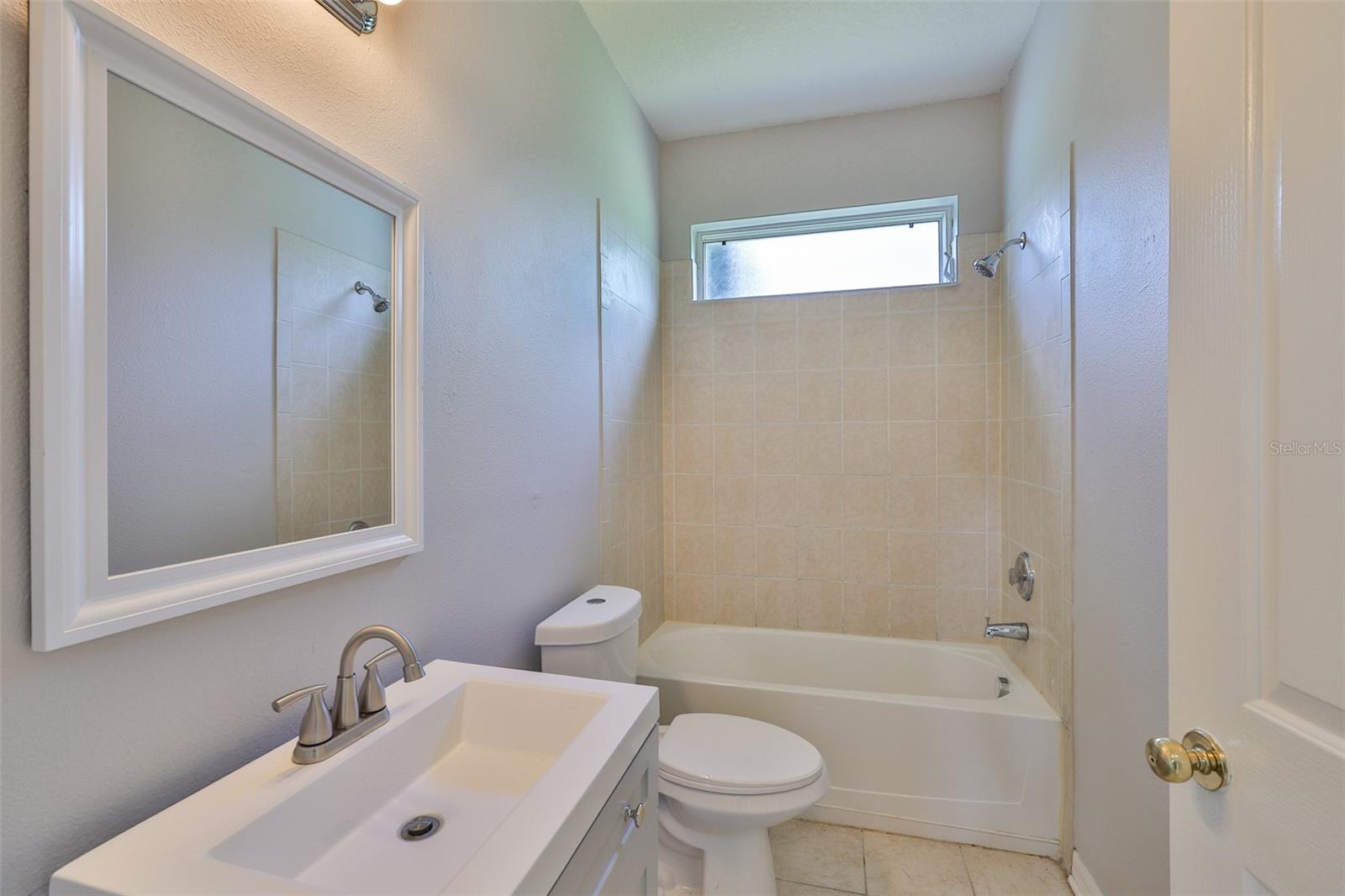 Bath 2 - new commode, new vanity, new mirror, tub/shower combo
