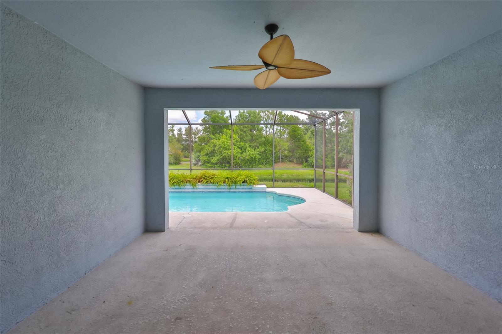 Covered lanai with ceiling fan from Great Room sliders