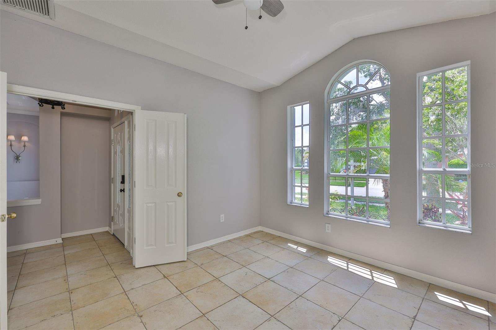 Office with french doors, vaulted ceiling and window wall