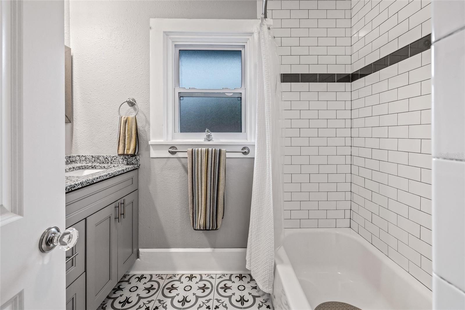 Classic subway tile and a nice tub/shower offer a clean, timeless look in the shared upstairs bathroom.