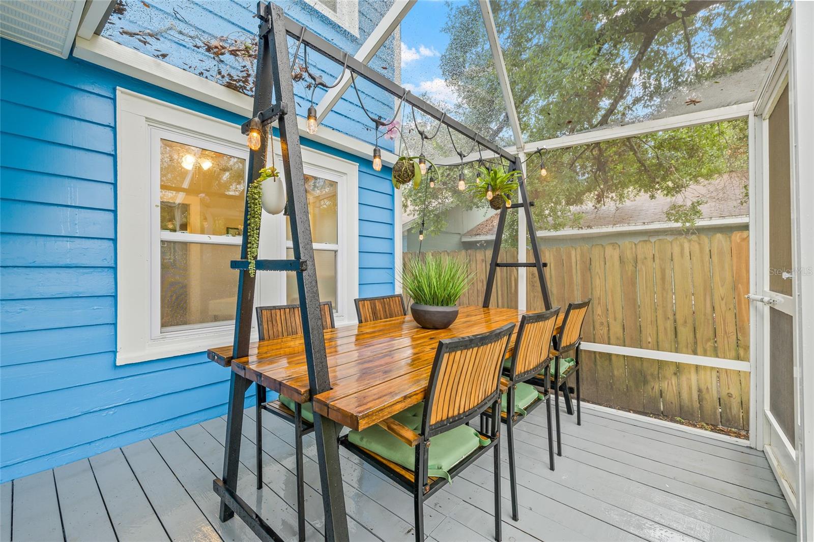 Enjoy al fresco meals in this screened-in dining space, ideal for gatherings year-round.