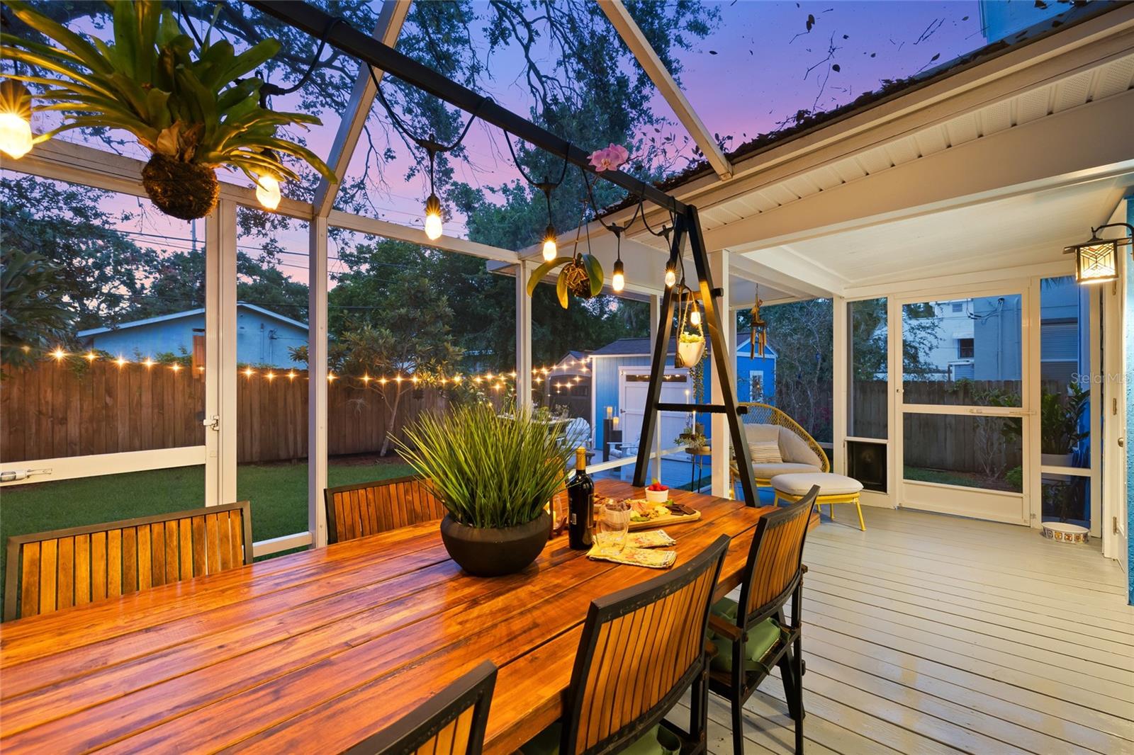 Entertain under the stars in this charming screened dining space that glows with warmth and character after dark.