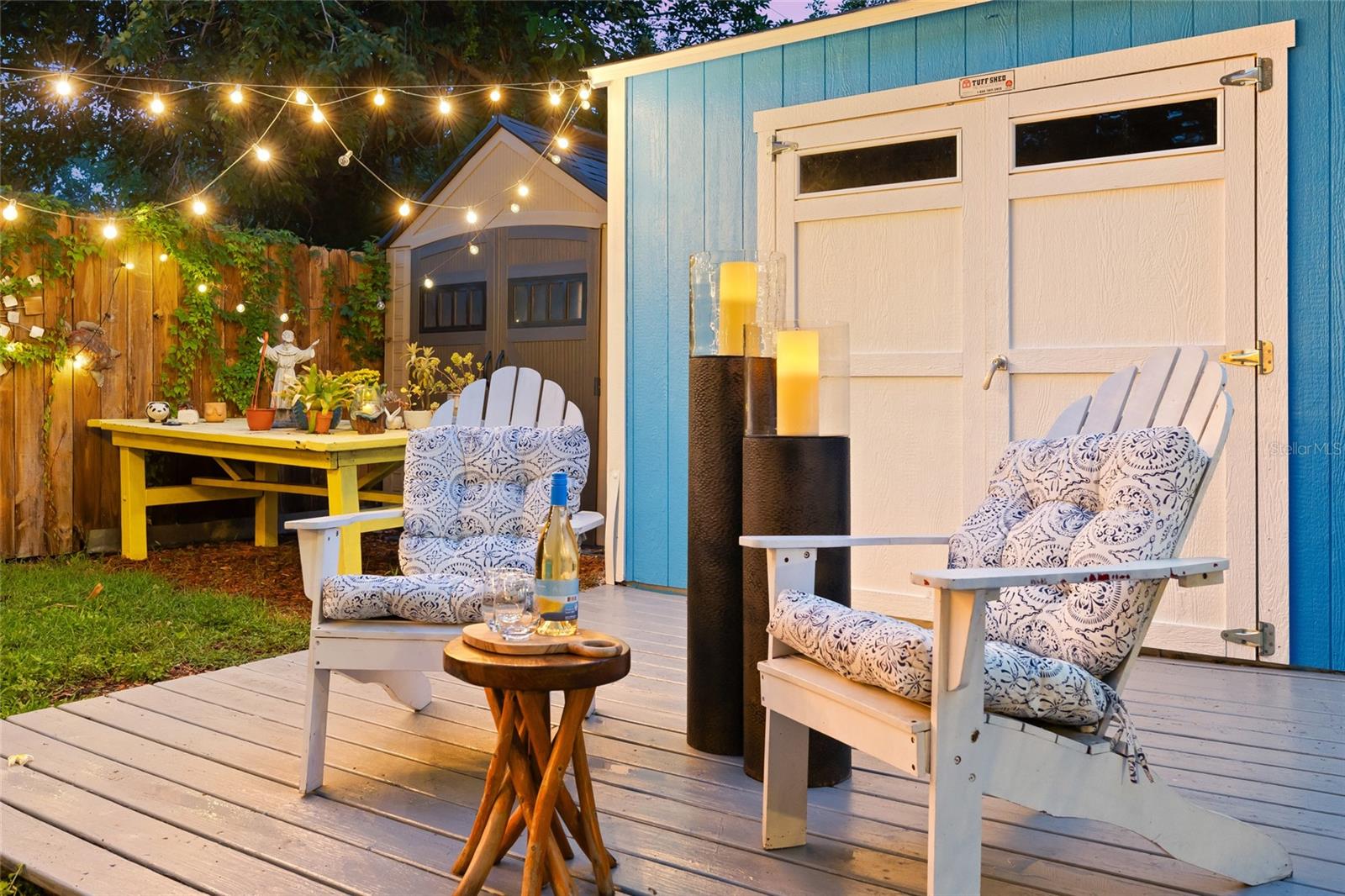 The backyard deck can become an intimate retreat, perfect for relaxing with a drink or enjoying a quiet night outdoors.