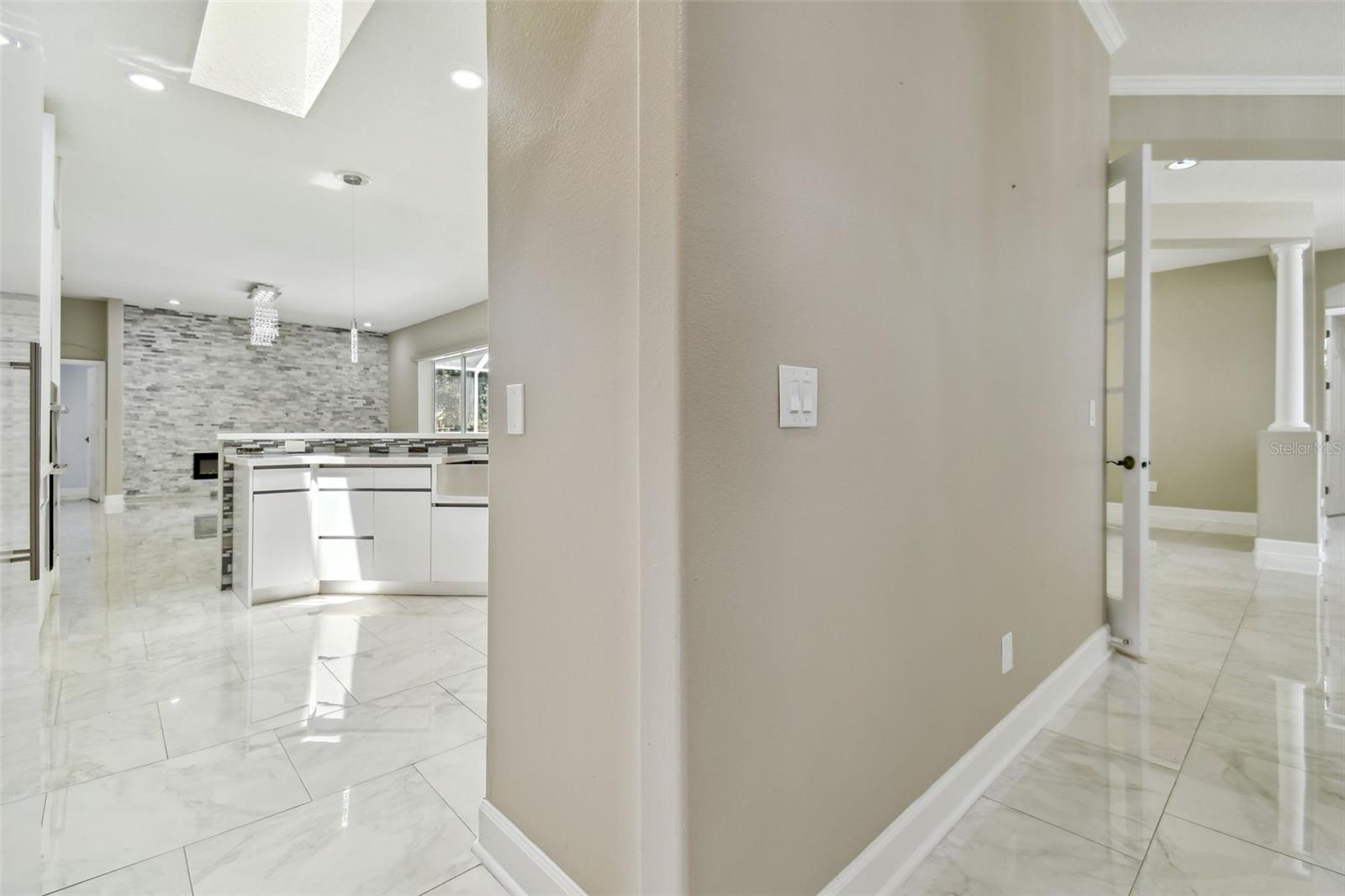 Formal living room leading to kitchen
