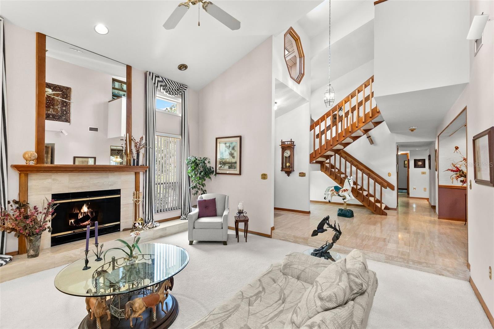 LIVING ROOM W/FIREPLACE AND STAIRCASE TO 2ND FL