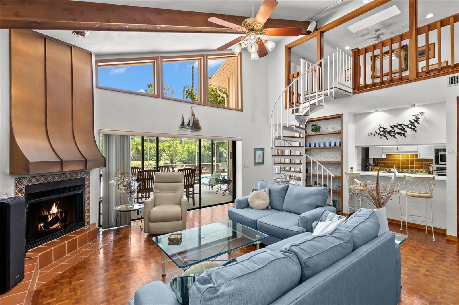 FAMILY ROOM WITH FIREPLACE SLIDERS TO POOL