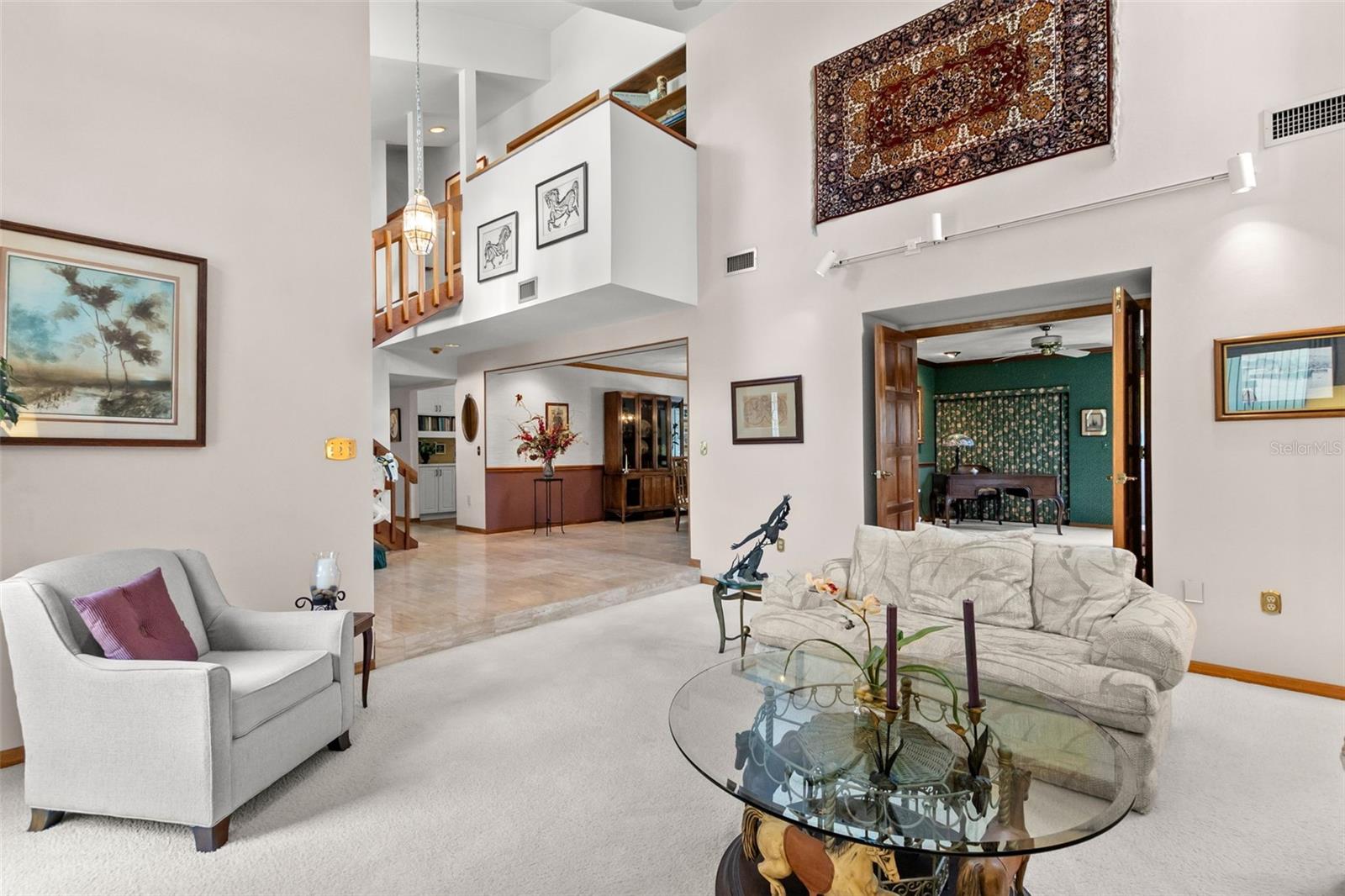 LIVING ROOM AND ENTRANCE TO ONE OF BEDROOMS/LIBRARY