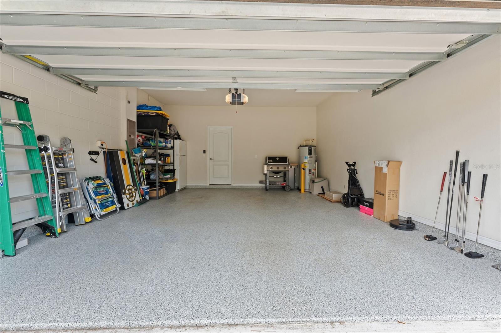 2 car garage with epoxy floor and extra overhead shelving for storage