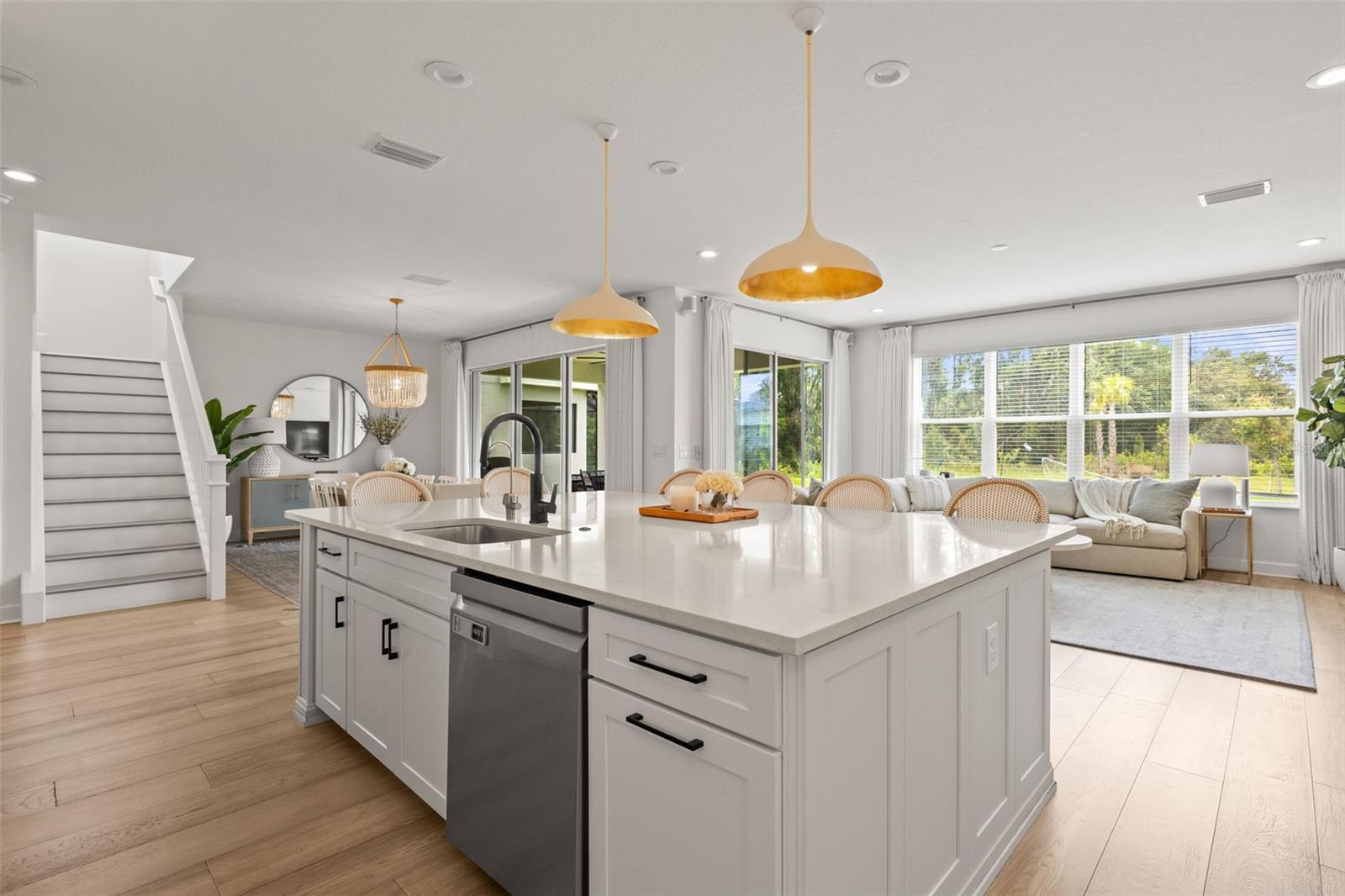 Oversized island featuring two roll-out garbage cabinets
