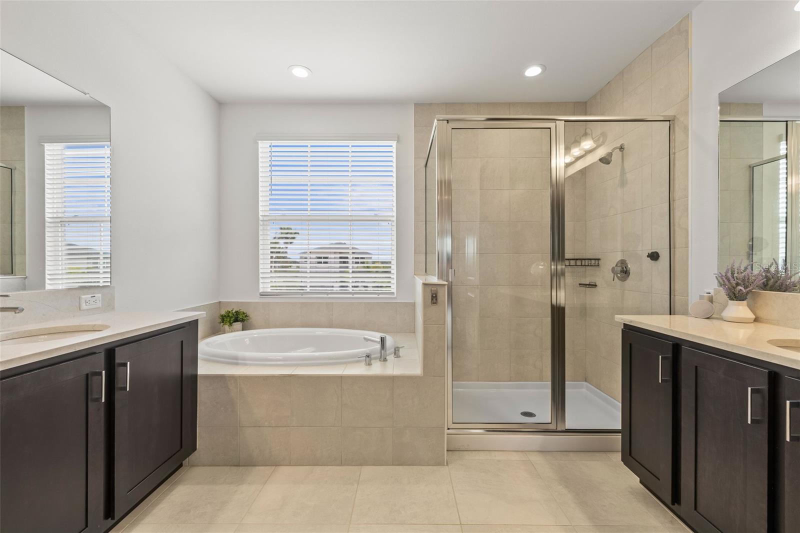 Primary bath with split vanities, Roman tub and shower