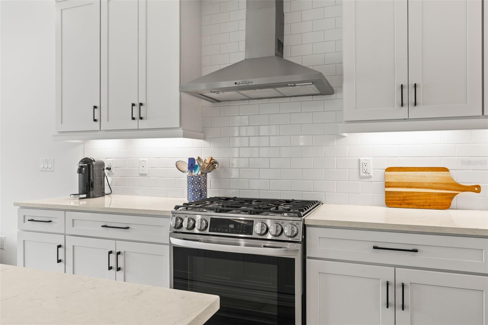 Gas stove with custom chimney vent hood