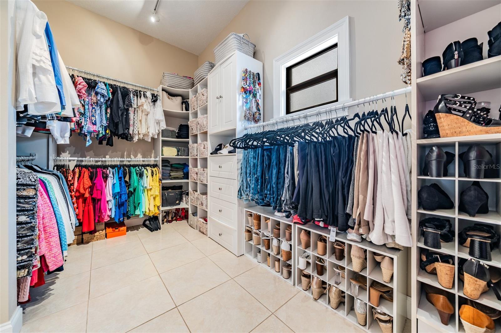 An enviable upgrade- the 14’x8’ walk-in closet with custom shelving that offers a boutique-style experience