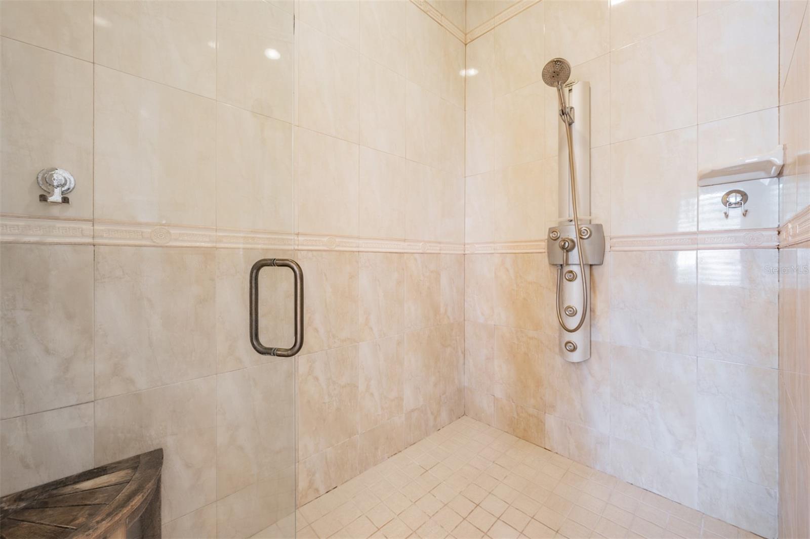 The stunning spa-inspired ensuite bath is designed to impress with dual designer stand-alone vanities, a luxurious Jacuzzi tub, a separate walk-in shower, a private toilet room, and sparkling tile finishes that add a touch of elegance to this relaxing sanctuary.