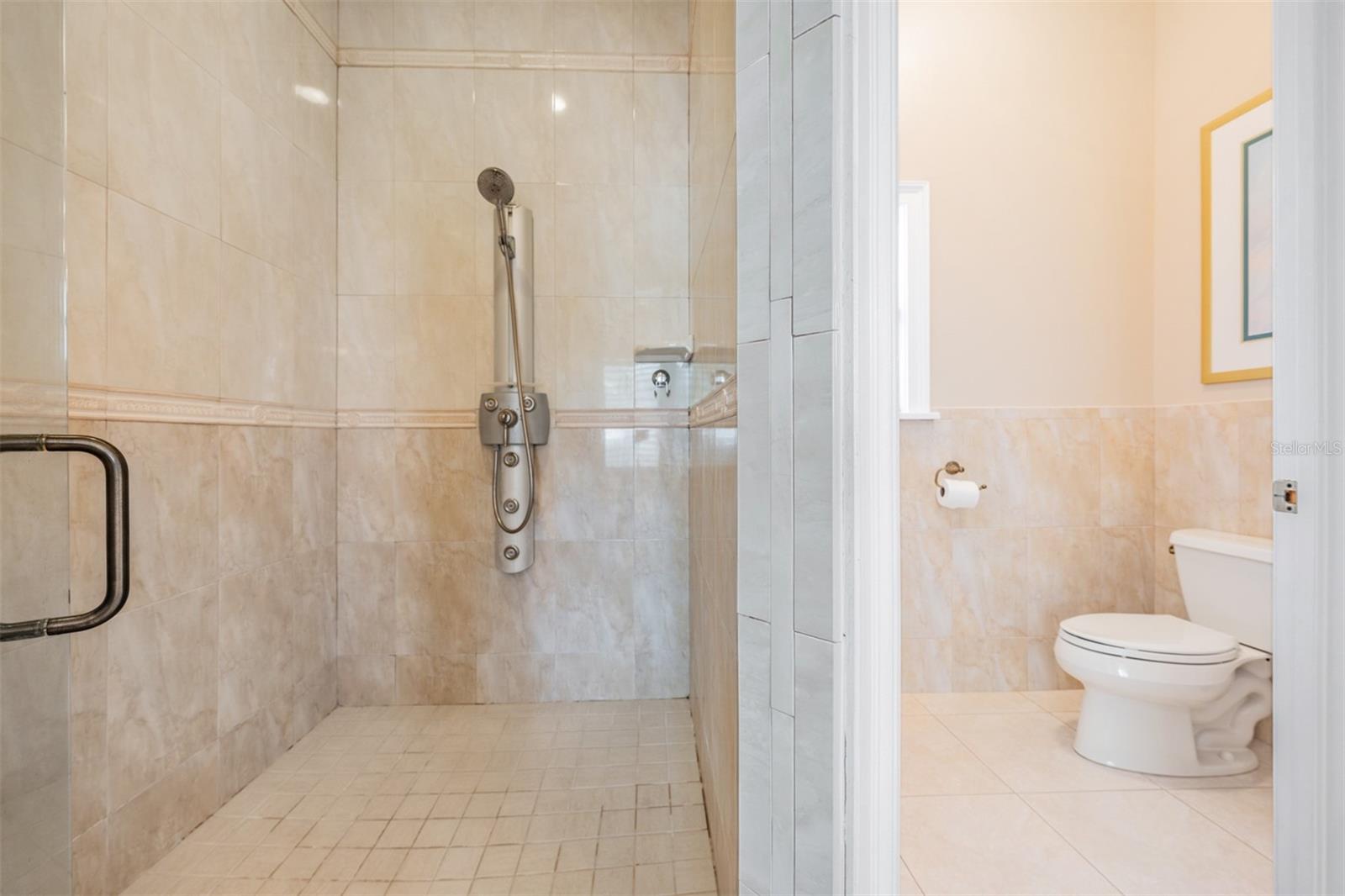 The stunning spa-inspired ensuite bath is designed to impress with dual designer stand-alone vanities, a luxurious Jacuzzi tub, a separate walk-in shower, a private toilet room, and sparkling tile finishes that add a touch of elegance to this relaxing sanctuary.