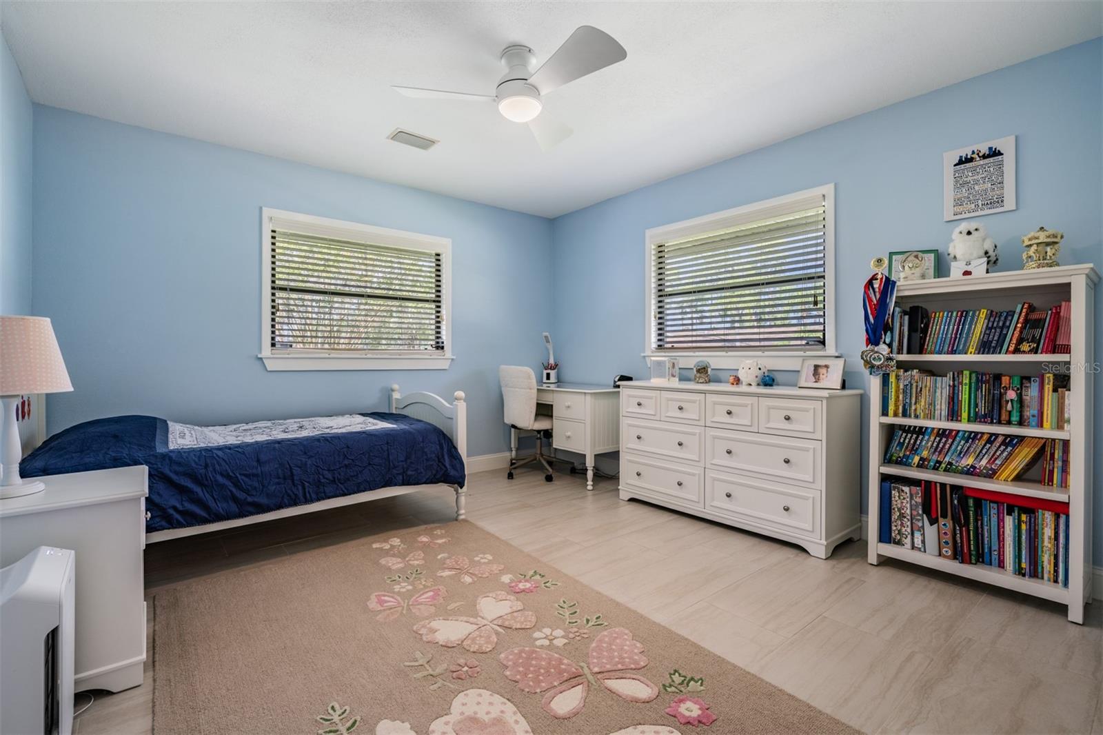 Fourth bedroom is a nice size with ceramic tile flooring, fresh paint, a wall closet and a modern fan