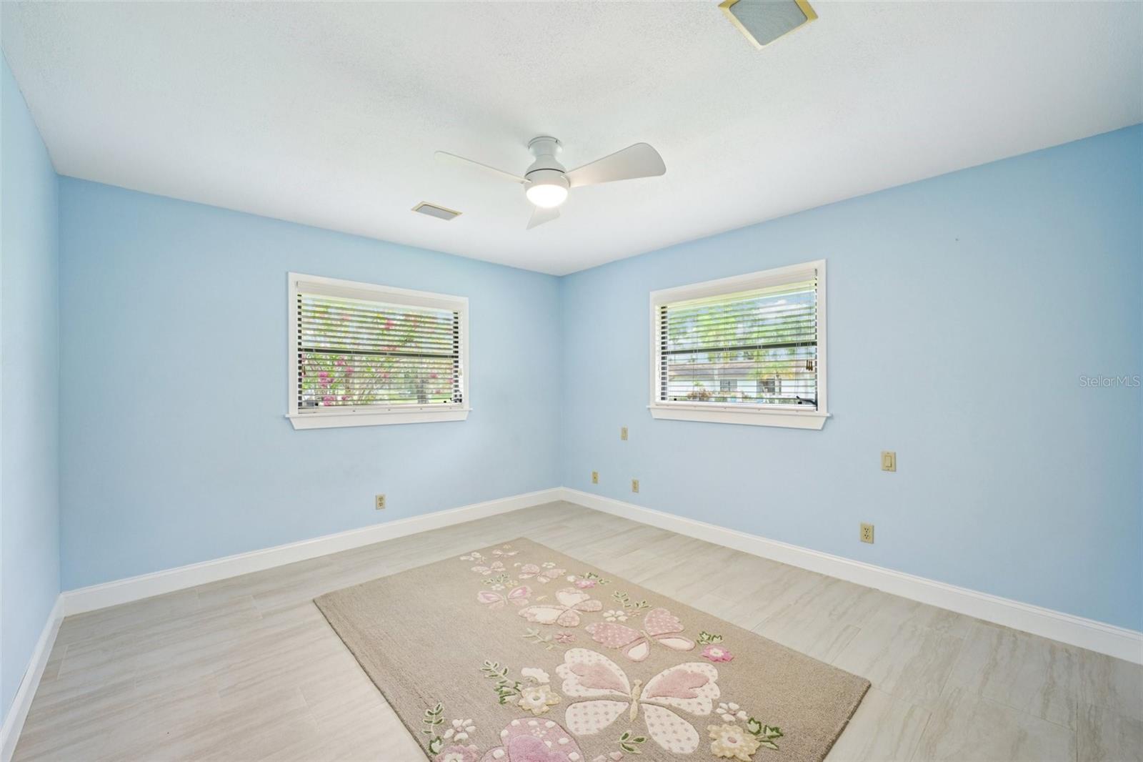 Fourth bedroom is a nice size with ceramic tile flooring, fresh paint, a wall closet and a modern fan