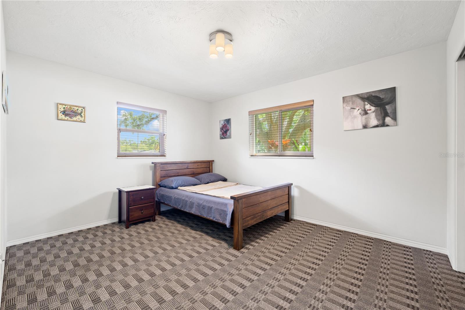 Spacious primary bedroom offers plenty of room for a king size bed