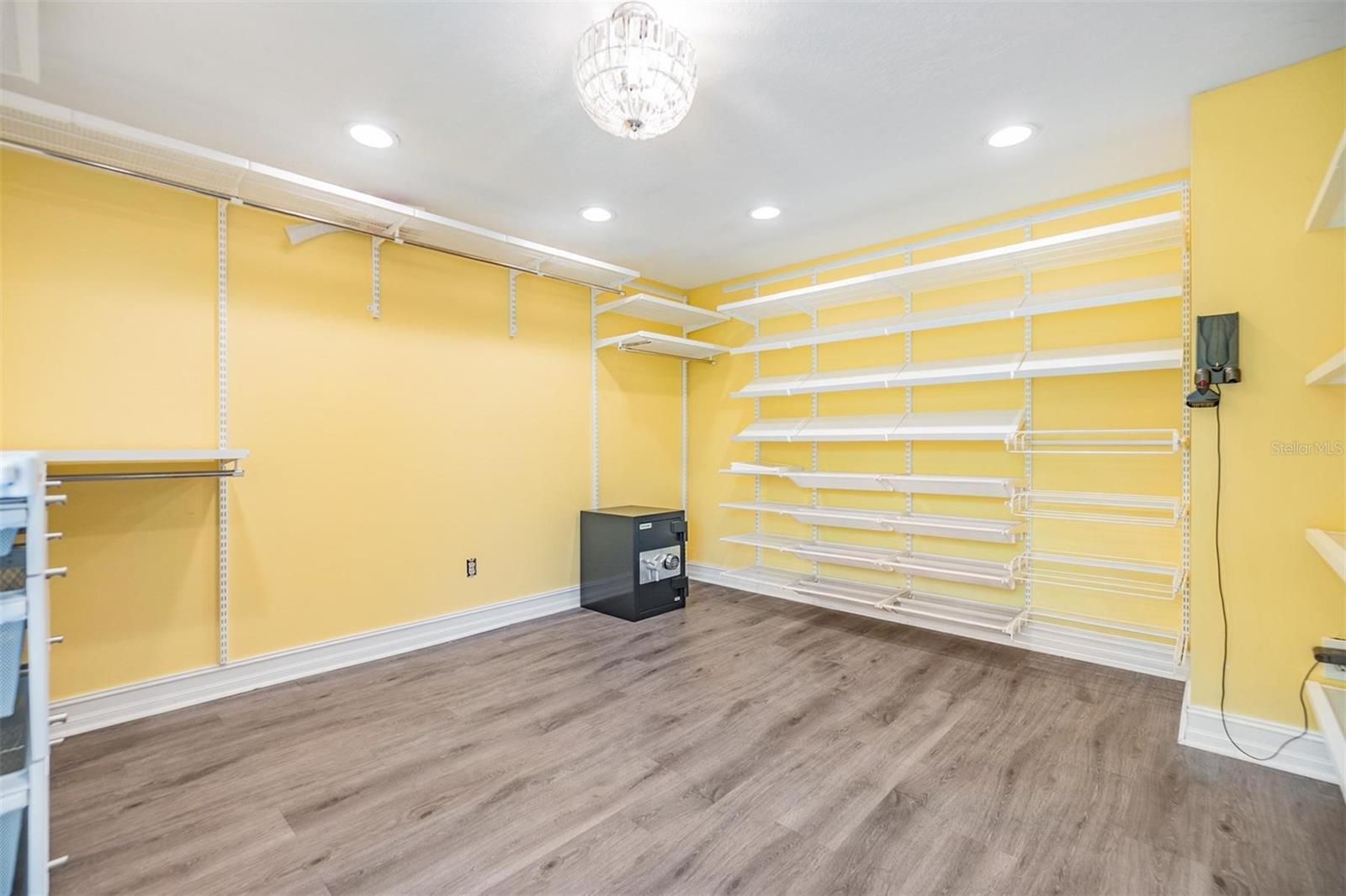 One of the tiny bedrooms was converted to a MASSIVE walk in closet for the primary bedroom