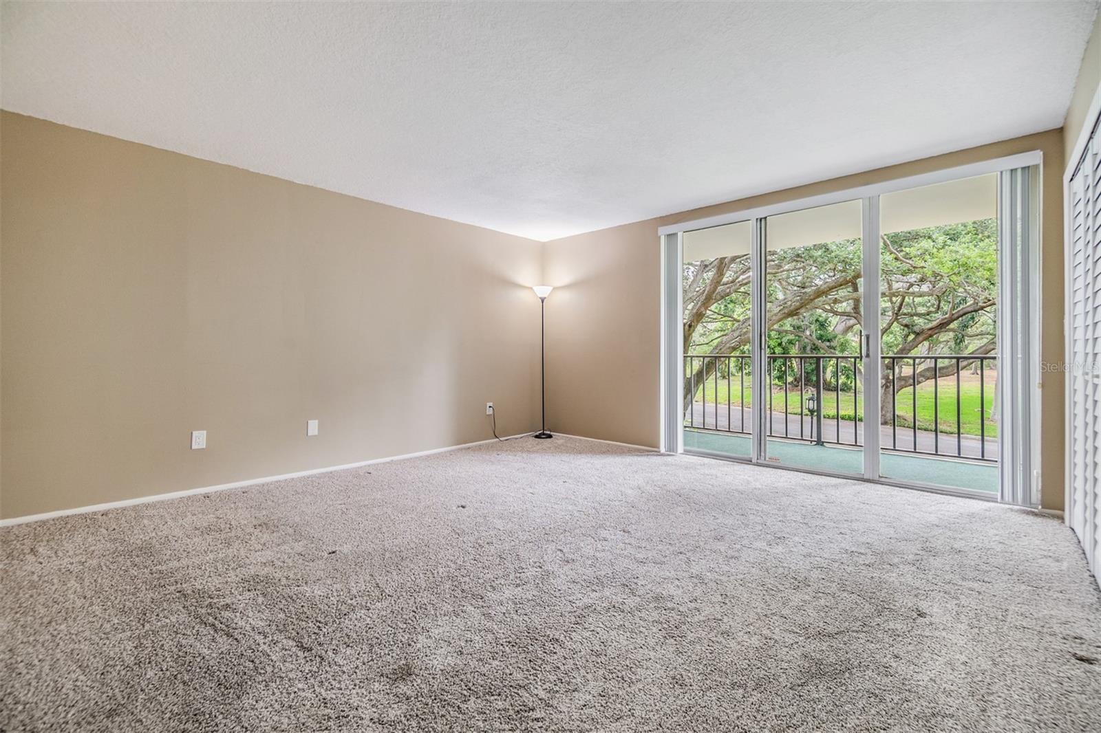 Primary Bedroom with sliding doors to the balcony.