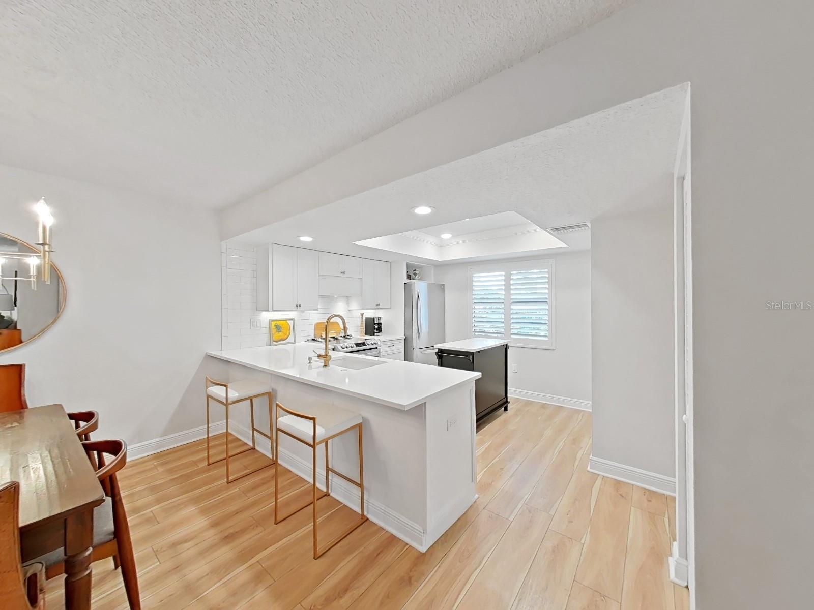 Kitchen with Breakfast Bar overlooks Dining Room