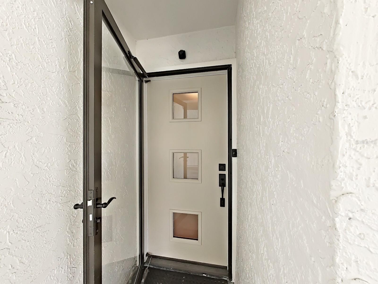 NEW modern, energy efficient front door (with full-view glass storm door).