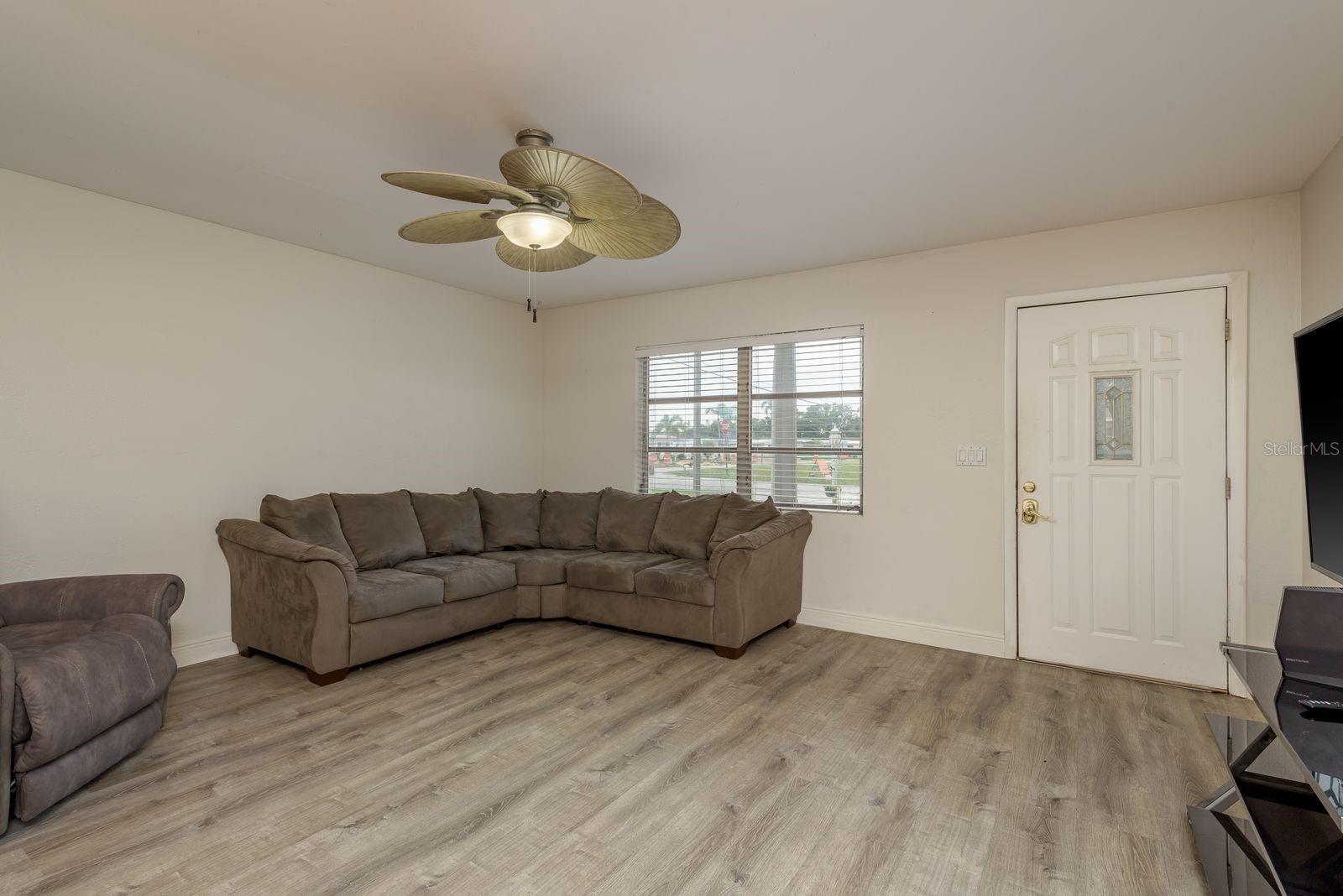 Spacious Living Room  with ceiling fan.
