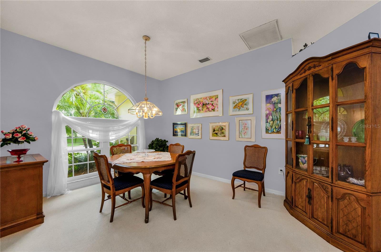 Great view of the Arch window at front of home, with table large enough to feed 10 when opened up.