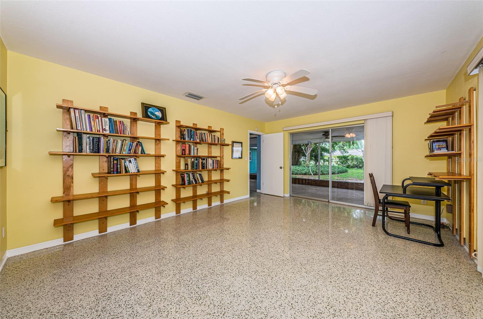 Primary bedroom overlooking screened porch and backyard.