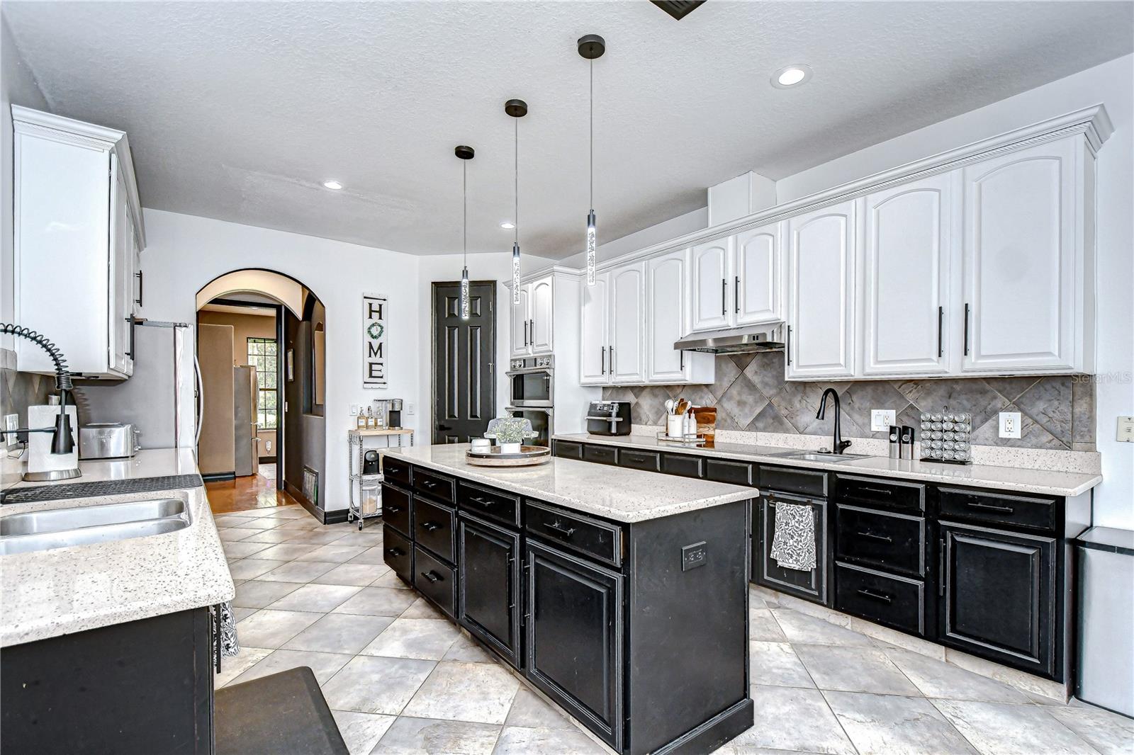Enjoy granite countertops, a tile backsplash, a large center island, wall oven, cooktop, & walk-in pantry!