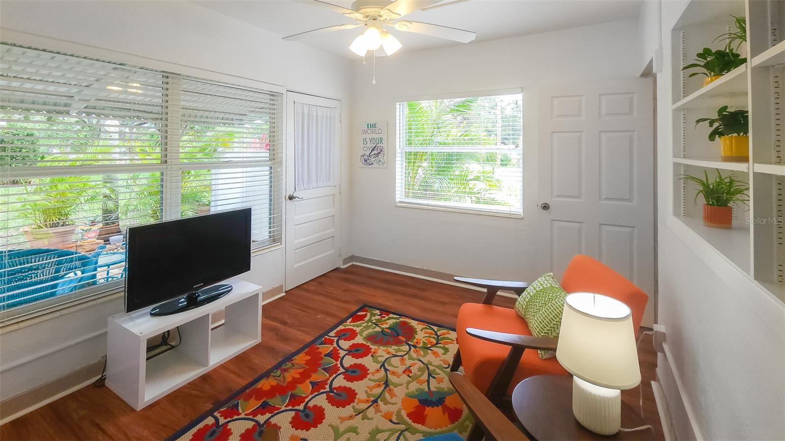 Large windows frame tropical views while keeping this cheerful Florida room light and airy all year round. Plus is cable connected so it can serve as a second TV room!