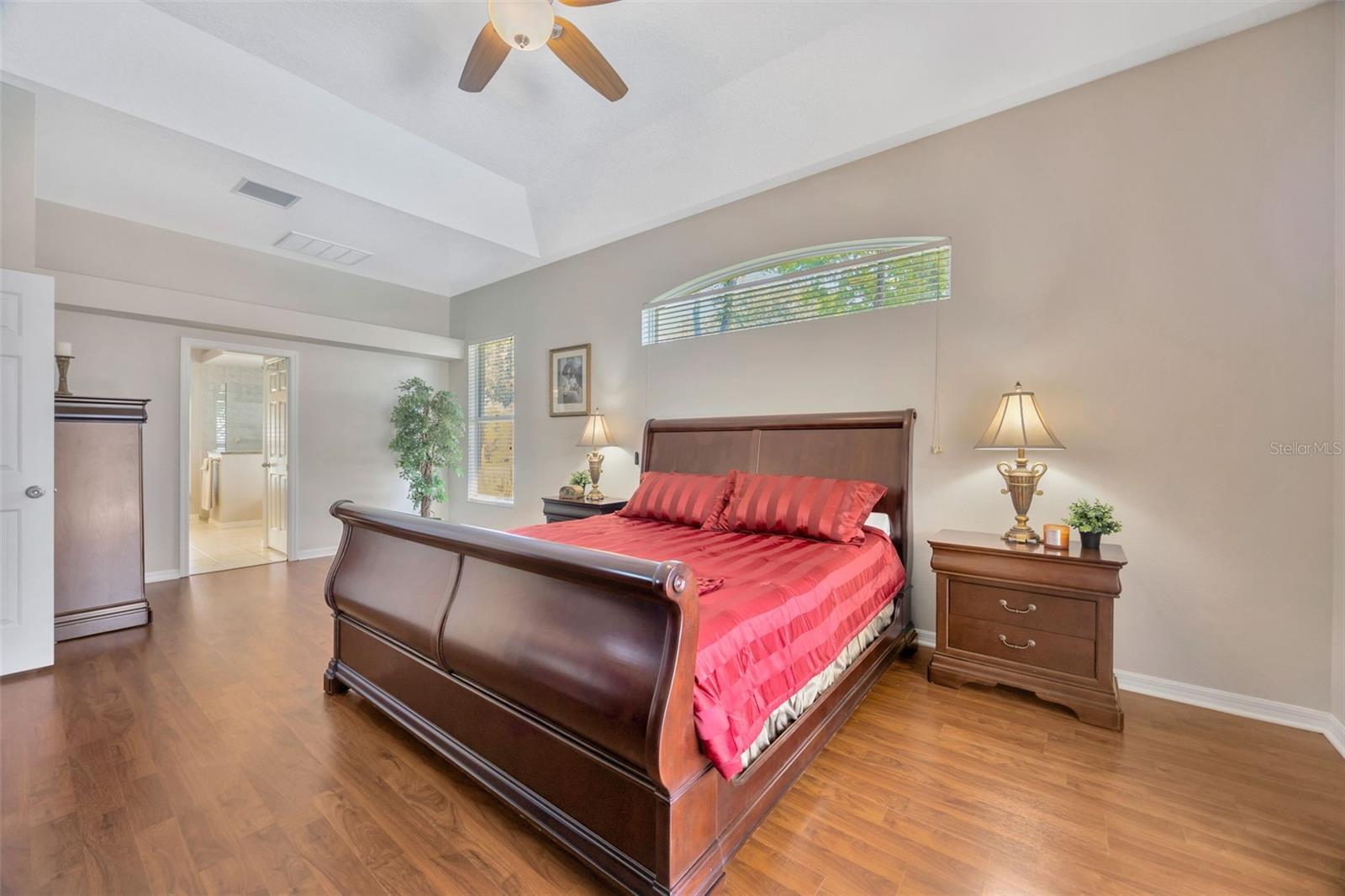 Primary Ensuite featuring upgraded bathroom, walk-in closet, and access to the lanai!