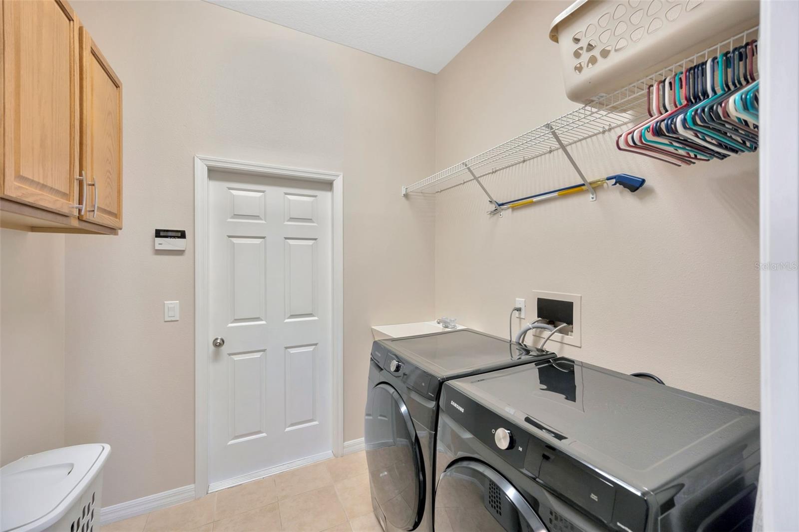 Laundry room w/ utility sink and cabinetry