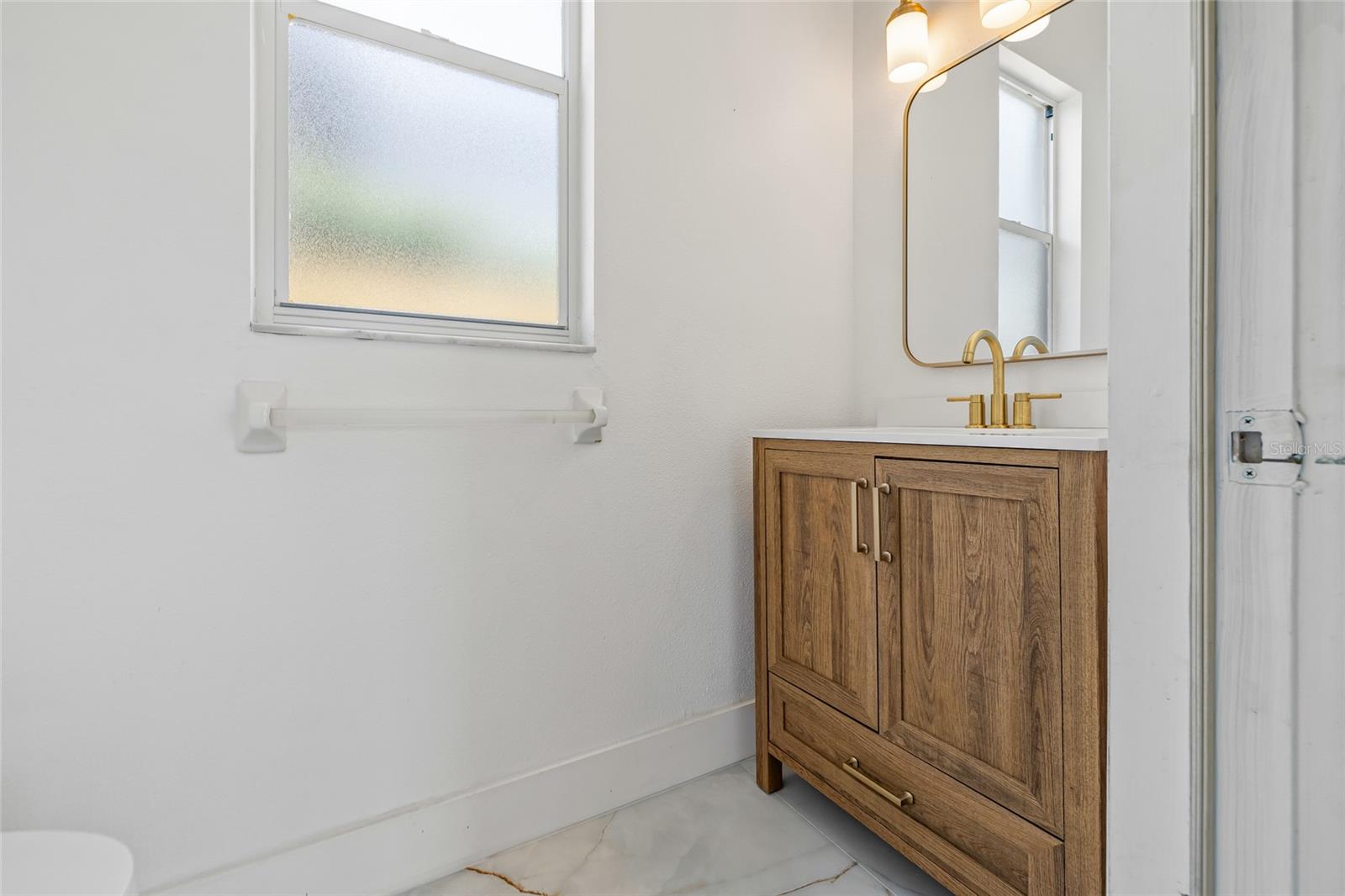 No wet feet from the pool in the house- a beautiful half bath by the pool!