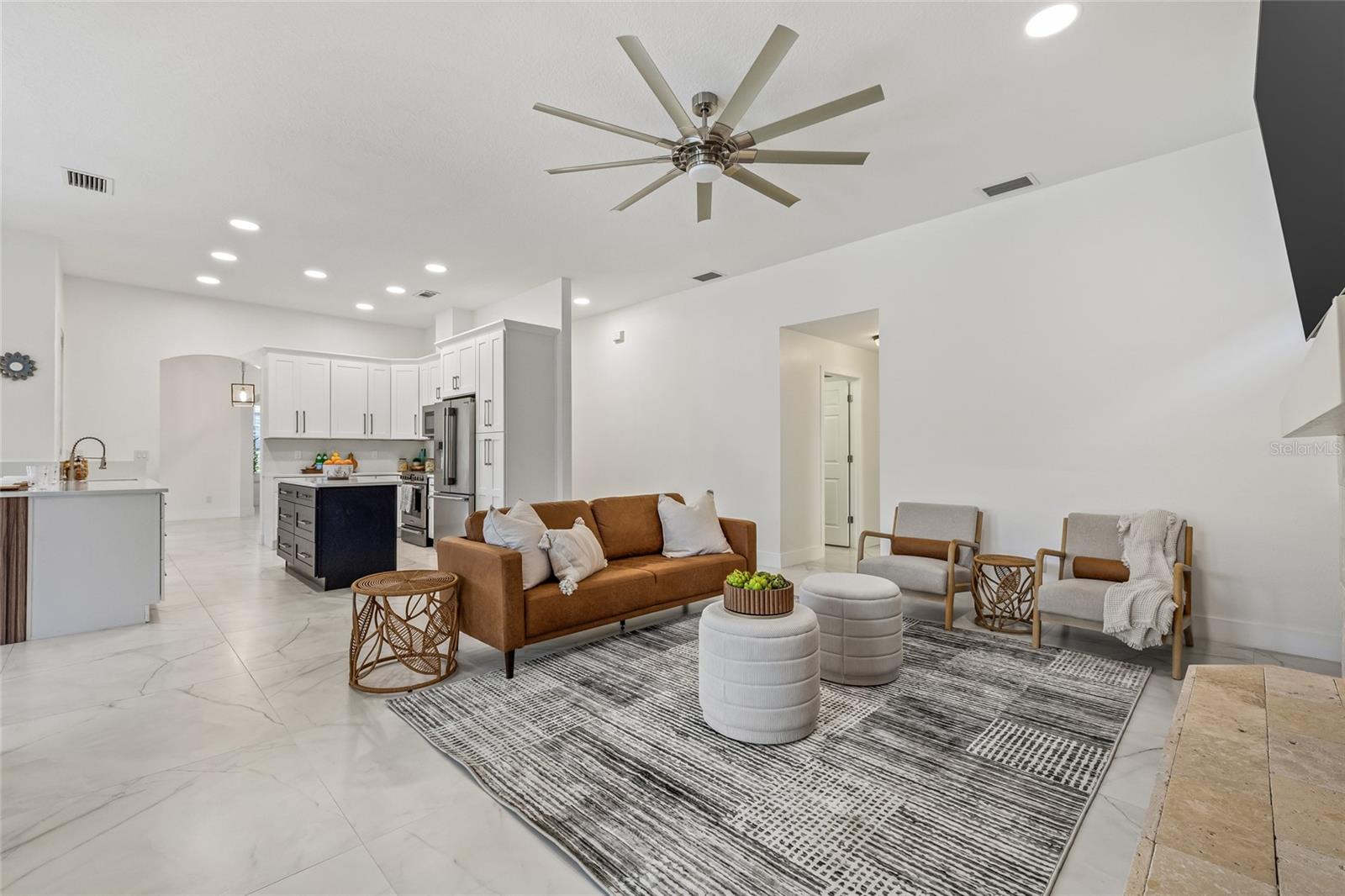 Free-flowing from the kitchen, enjoy the hearth room with a wood burning fireplace. (Furniture is physically staged).